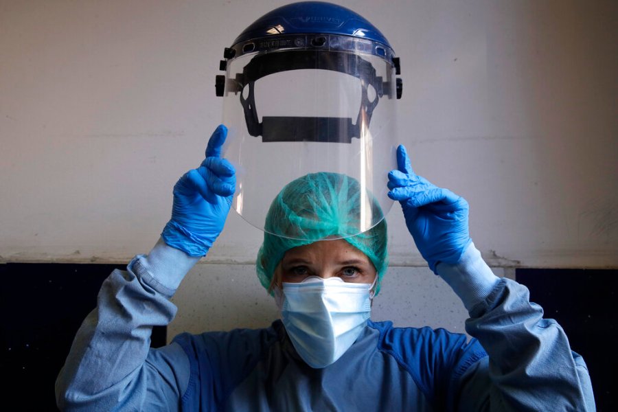 Monica Carfora, deputy head of the emergency of the Santo Spirito Hospital in central Rome, poses to show how to wear protective gear. (AP Photo/Alessandra Tarantino)