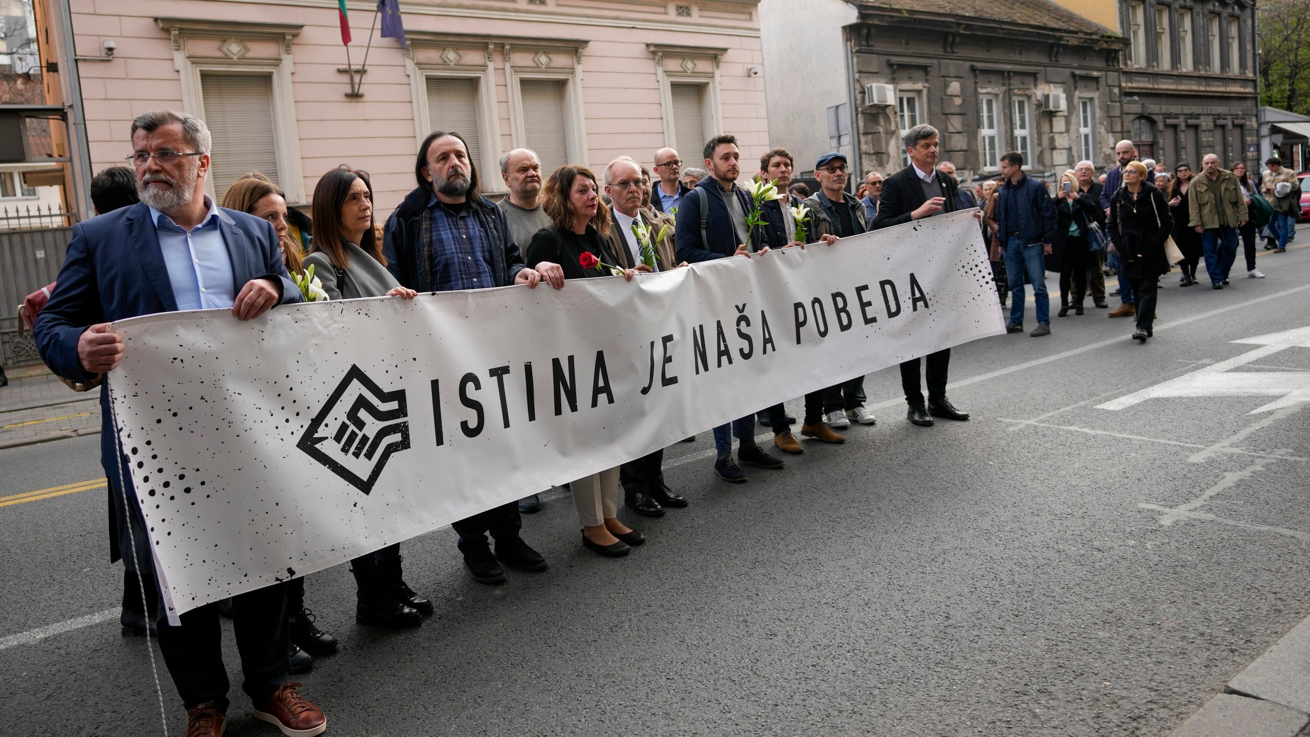 Serbian journalists hold banner reading: "Truth is our victory" as they march to mark the 24th anniversary of the killing of a prominent editor and newspaper publisher Slavko Curuvija who was fiercely critical of the government, in Belgrade, Serbia, Tuesday, April 11, 2023. Independent media organizations, both local and international, warn that critical journalists still face threats because of their work. (AP Photo/Darko Vojinovic)