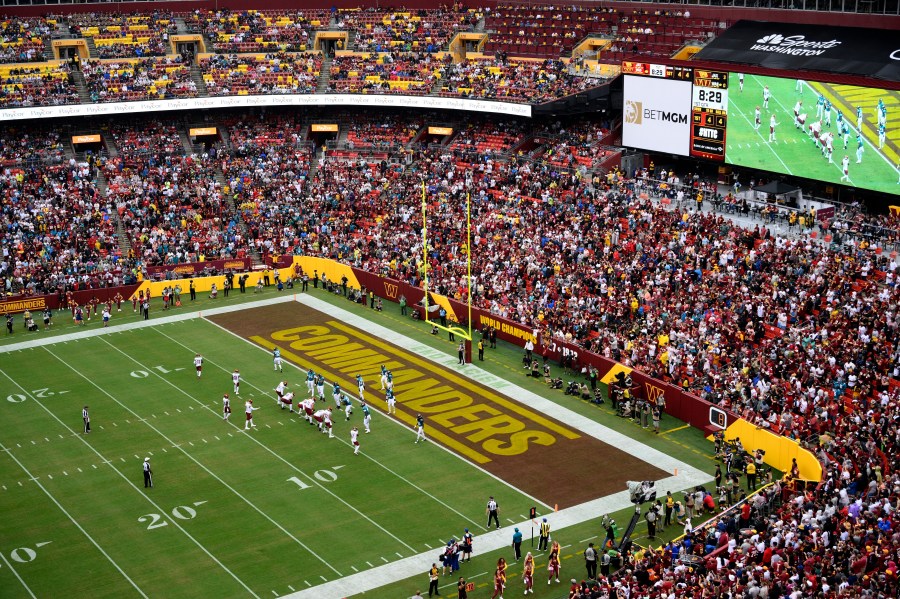 FILE - Fans watch as the Washington Commanders face the Jacksonville Jaguars in an NFL football game, Sunday, Sept. 11, 2022, in Landover, Md. A group led by Josh Harris and Mitchell Rales that includes Magic Johnson has an agreement in principle to buy the NFL's Washington Commanders from longtime owner Dan Snyder for a North American professional sports team record $6 billion, according to a person with knowledge of the situation. The person spoke to The Associated Press on condition of anonymity Thursday, April 13, 2023, because the deal had not been announced. (AP Photo/Nick Wass, File)
