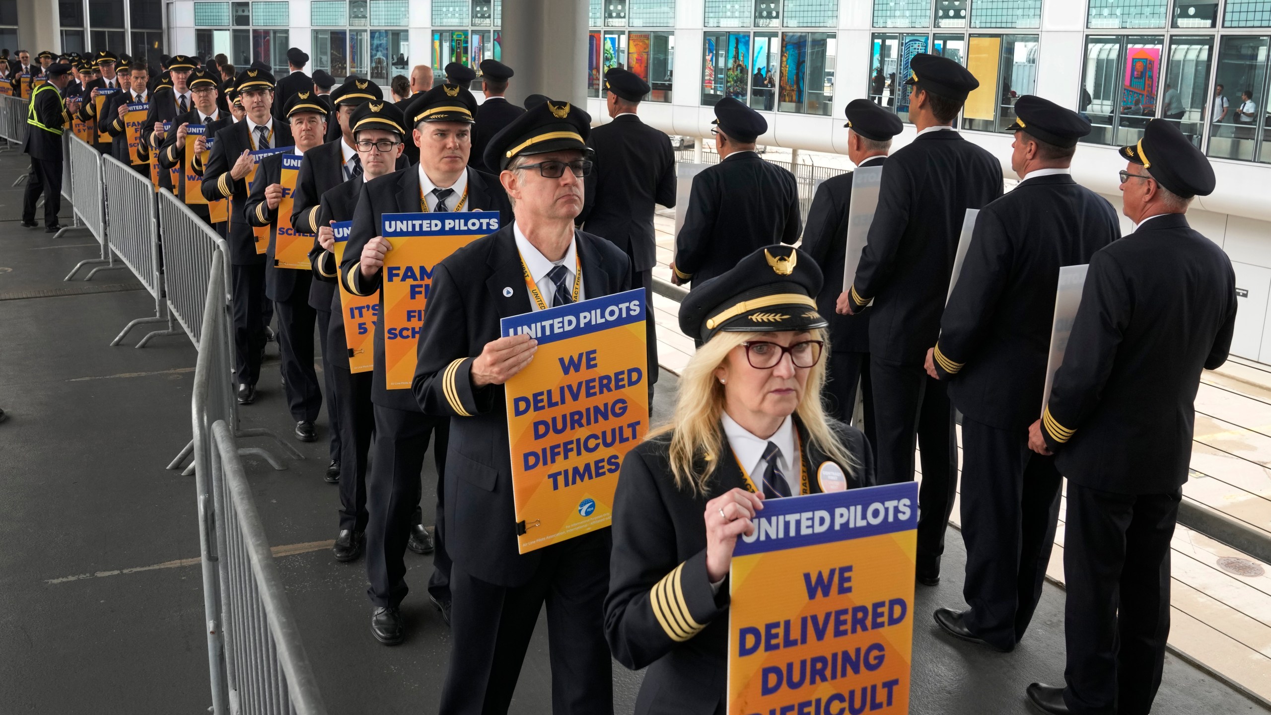 Members of the Air Line Pilots Association International walk an informational picket on behalf of United Airline pilots at O'Hare International Airport Friday, May 12, 2023, in Chicago. (AP Photo/Charles Rex Arbogast)
